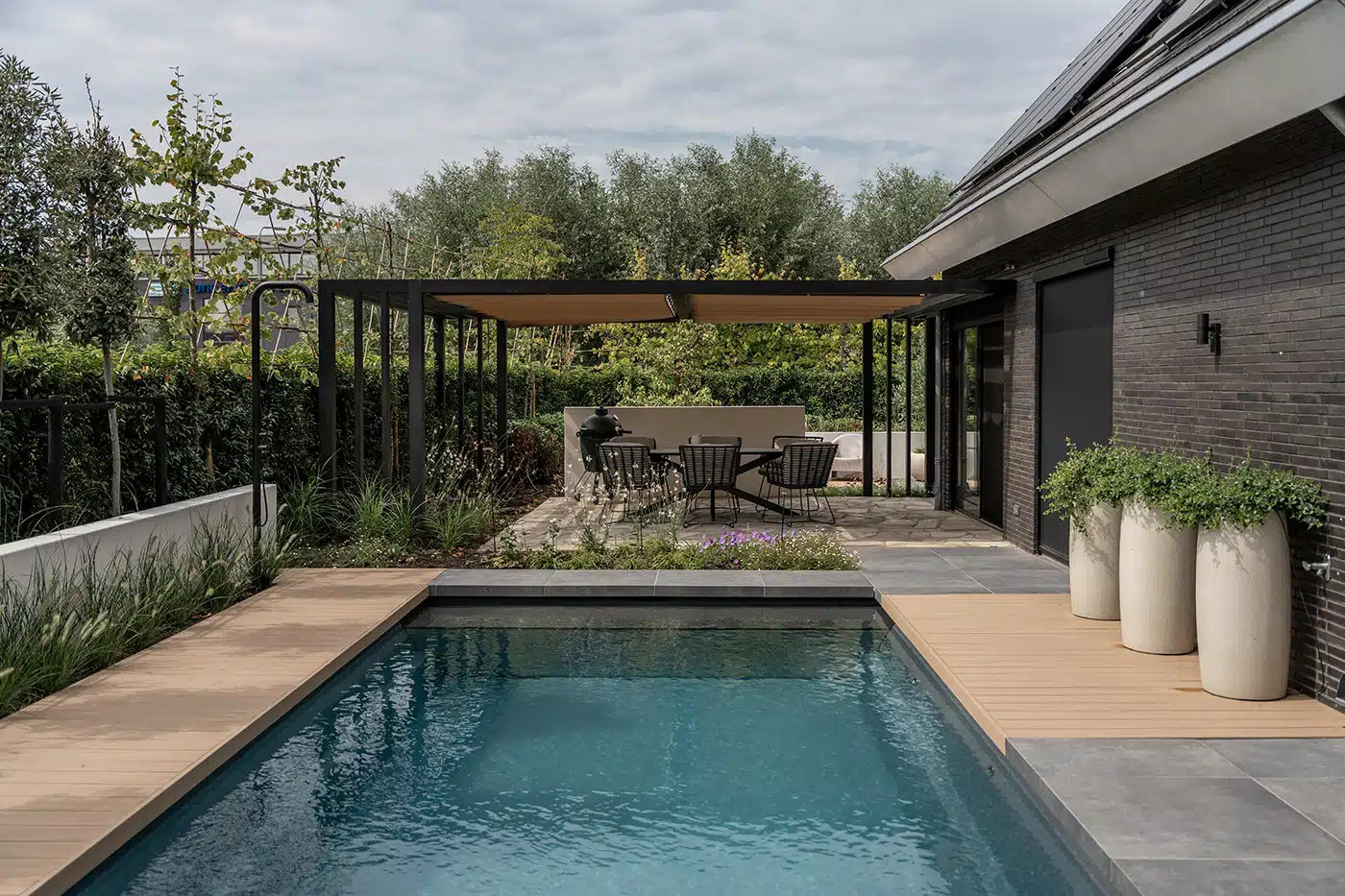 Contemporary garden with a pool and TimberTech decking