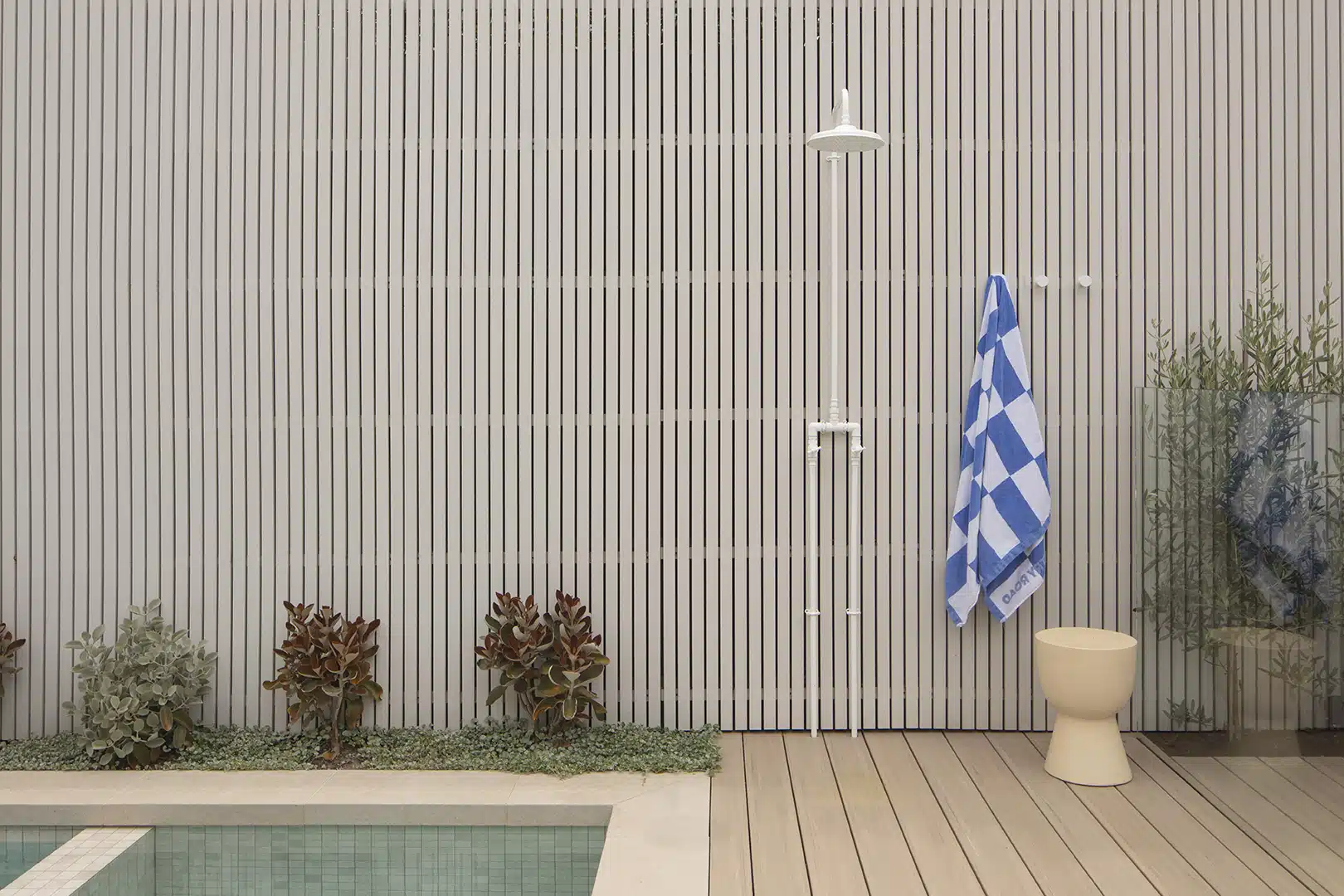 Outdoor shower beside a contemporary pool, framed by TimberTech decking for a seamless resort-style outdoor living experience.